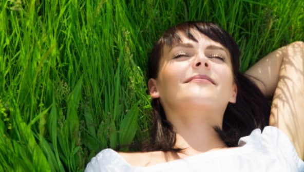 beautiful girl lying down of grass. Copy space