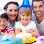 Smiling family celebrating a birthday Smiling family celebrating a birthday