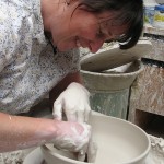 woman throwing clay